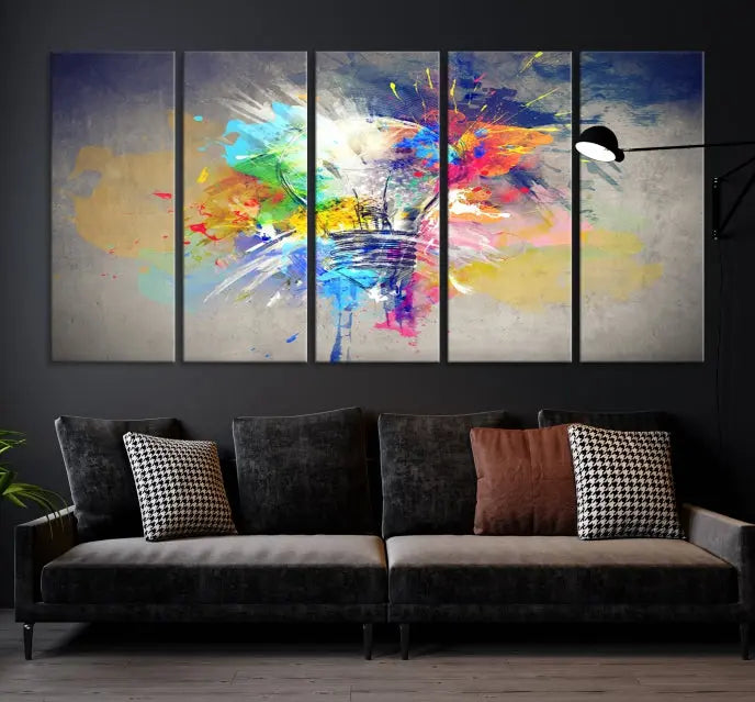 The Lamp Abstract Color Wall Art Canvas Print showcases vibrant splashes of color around a light bulb design. This museum-quality canvas comes ready to hang and features a UV-protective coating to keep its colors vivid and striking for years.