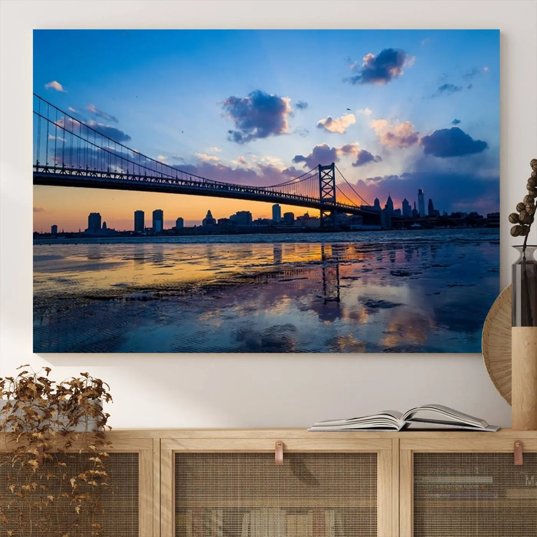 A photograph titled "Large Wall Art Philadelphia Canvas Print - Benjamin Franklin Bridge at Sunset" displays a breathtaking cityscape of the bridge reflected in the water. This image features a gallery-quality finish that promises to transform any space into an evocative memory.