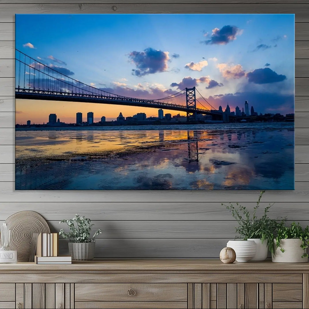 A photograph titled "Large Wall Art Philadelphia Canvas Print - Benjamin Franklin Bridge at Sunset" displays a breathtaking cityscape of the bridge reflected in the water. This image features a gallery-quality finish that promises to transform any space into an evocative memory.