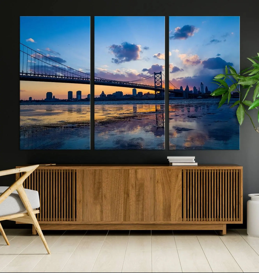 A photograph titled "Large Wall Art Philadelphia Canvas Print - Benjamin Franklin Bridge at Sunset" displays a breathtaking cityscape of the bridge reflected in the water. This image features a gallery-quality finish that promises to transform any space into an evocative memory.