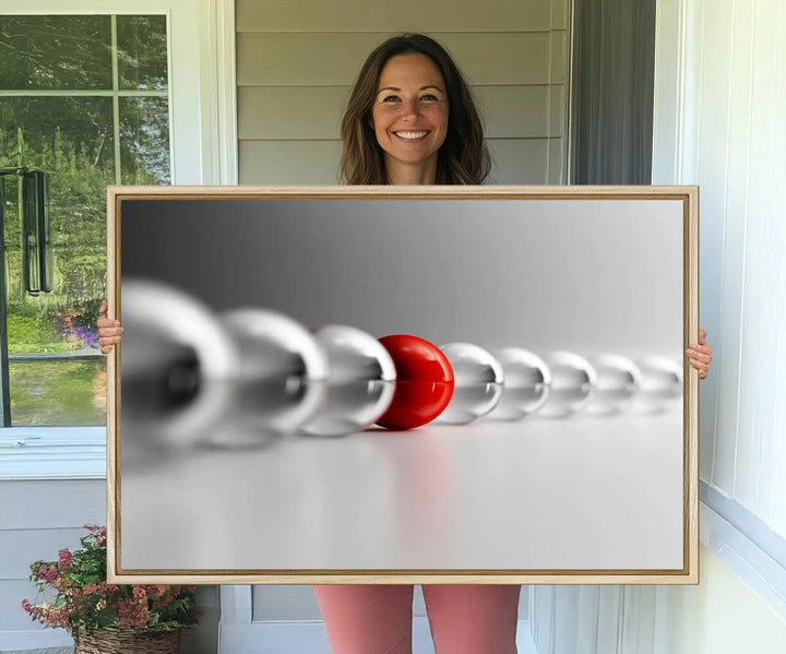 Displayed in a dining room, the Red Ball in Gray Balls canvas boasts a gallery-quality finish.