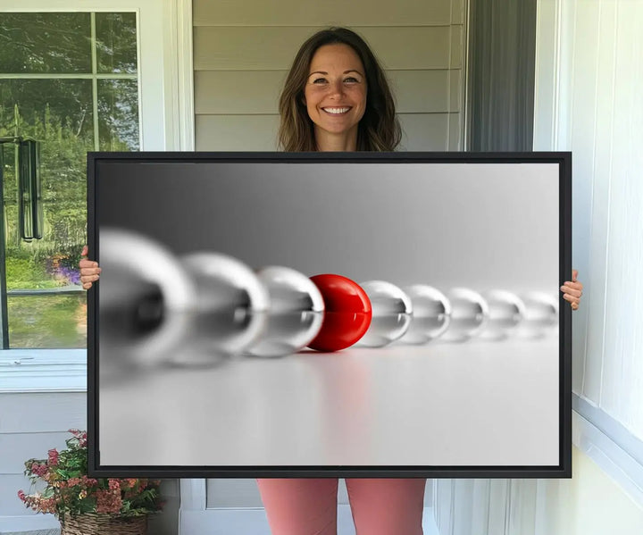 Displayed in a dining room, the Red Ball in Gray Balls canvas boasts a gallery-quality finish.