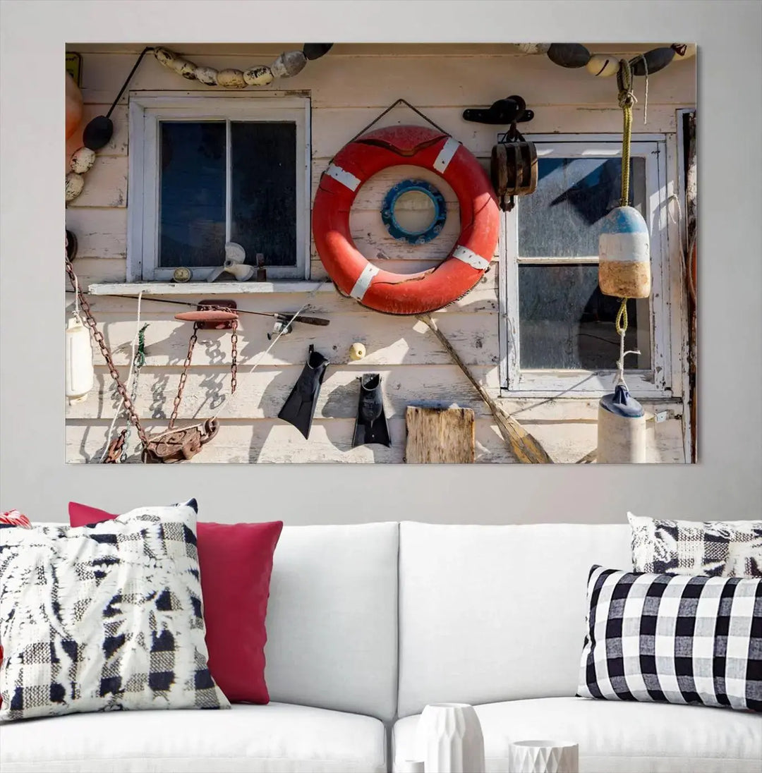 The living room features the Lifebuoy Wall Art Nautical Canvas Print, a museum-quality piece that showcases a lifebuoy alongside fishing gear. The artwork is ready to hang and includes a UV-protective coating to ensure lasting vibrancy.