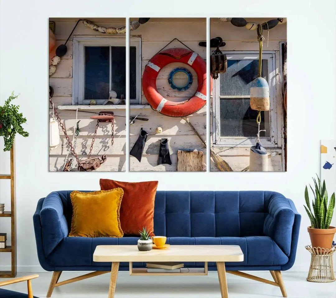 The living room features the Lifebuoy Wall Art Nautical Canvas Print, a museum-quality piece that showcases a lifebuoy alongside fishing gear. The artwork is ready to hang and includes a UV-protective coating to ensure lasting vibrancy.