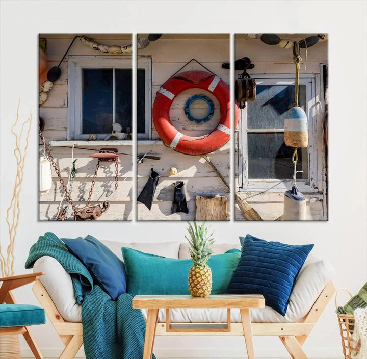 The living room features the Lifebuoy Wall Art Nautical Canvas Print, a museum-quality piece that showcases a lifebuoy alongside fishing gear. The artwork is ready to hang and includes a UV-protective coating to ensure lasting vibrancy.