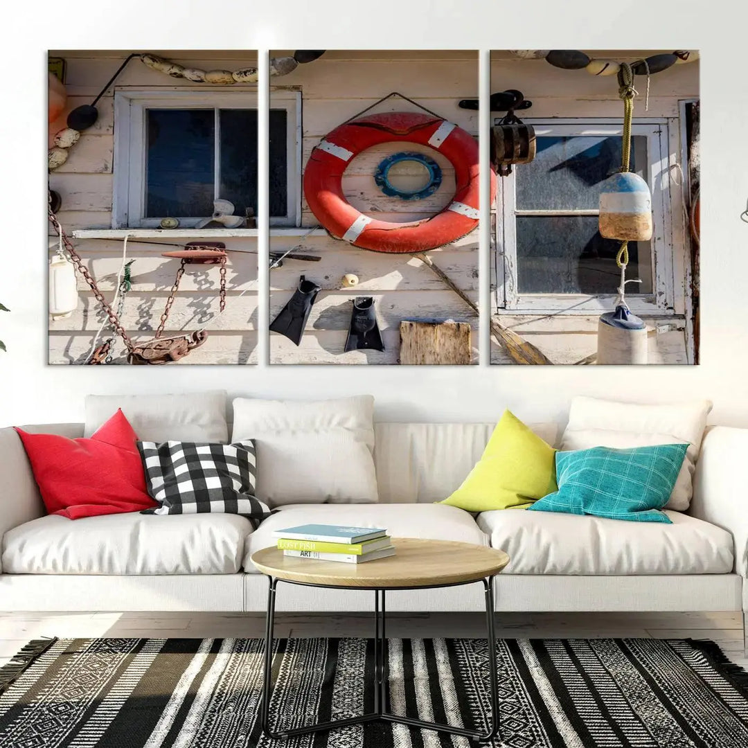 The living room features the Lifebuoy Wall Art Nautical Canvas Print, a museum-quality piece that showcases a lifebuoy alongside fishing gear. The artwork is ready to hang and includes a UV-protective coating to ensure lasting vibrancy.