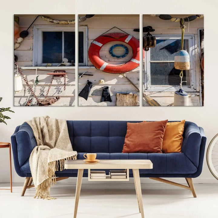 The living room features the Lifebuoy Wall Art Nautical Canvas Print, a museum-quality piece that showcases a lifebuoy alongside fishing gear. The artwork is ready to hang and includes a UV-protective coating to ensure lasting vibrancy.