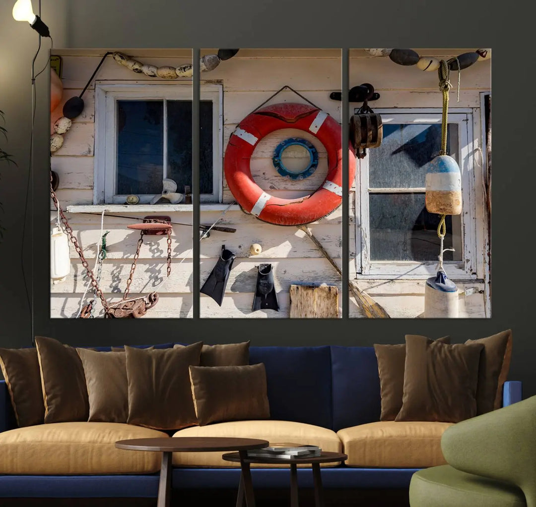 The living room features the Lifebuoy Wall Art Nautical Canvas Print, a museum-quality piece that showcases a lifebuoy alongside fishing gear. The artwork is ready to hang and includes a UV-protective coating to ensure lasting vibrancy.