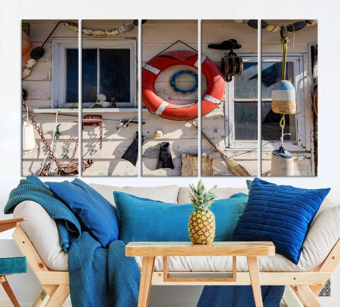 The living room features the Lifebuoy Wall Art Nautical Canvas Print, a museum-quality piece that showcases a lifebuoy alongside fishing gear. The artwork is ready to hang and includes a UV-protective coating to ensure lasting vibrancy.