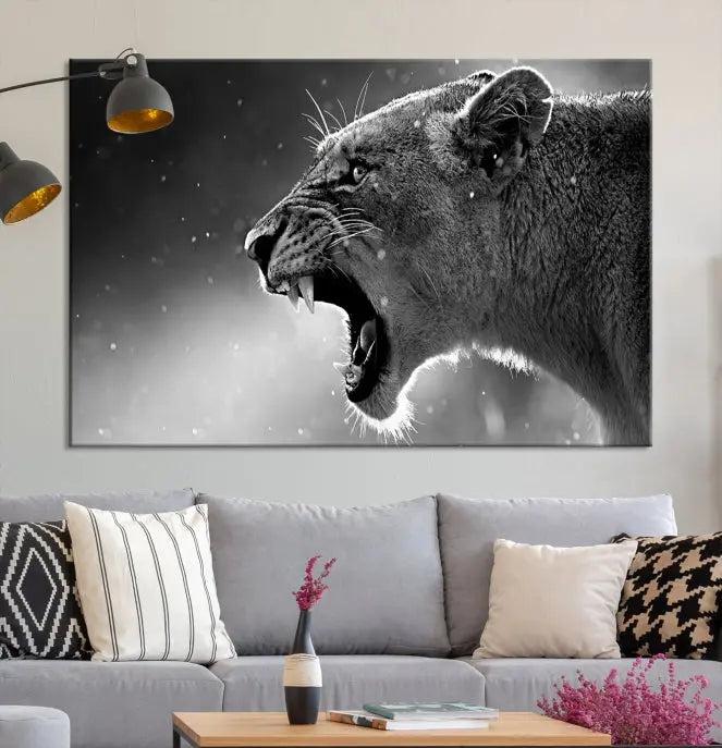 A Lion Wall Art Canvas Print depicting a roaring lioness in black and white, expertly gallery wrapped with UV-protective coating, is displayed in the living room.