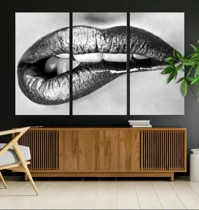 A striking triptych of Lip Bite Wall Art Canvas Print, featuring glossy metallic lips, gleams against a black background. Its UV-protective coating guarantees enduring vibrancy.