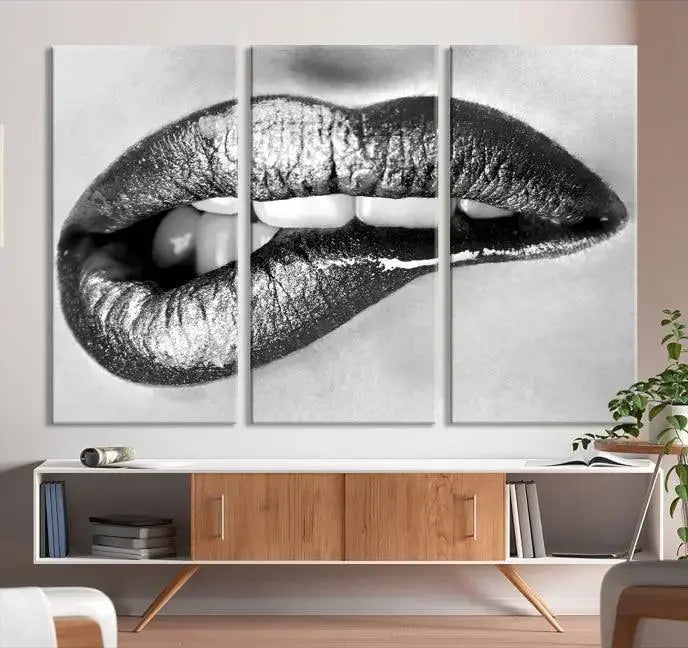 A striking triptych of Lip Bite Wall Art Canvas Print, featuring glossy metallic lips, gleams against a black background. Its UV-protective coating guarantees enduring vibrancy.