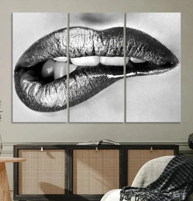 A striking triptych of Lip Bite Wall Art Canvas Print, featuring glossy metallic lips, gleams against a black background. Its UV-protective coating guarantees enduring vibrancy.