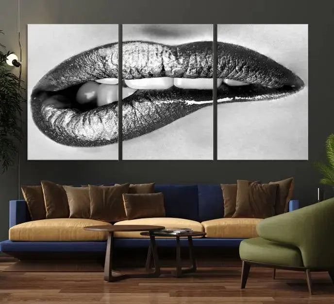 A striking triptych of Lip Bite Wall Art Canvas Print, featuring glossy metallic lips, gleams against a black background. Its UV-protective coating guarantees enduring vibrancy.