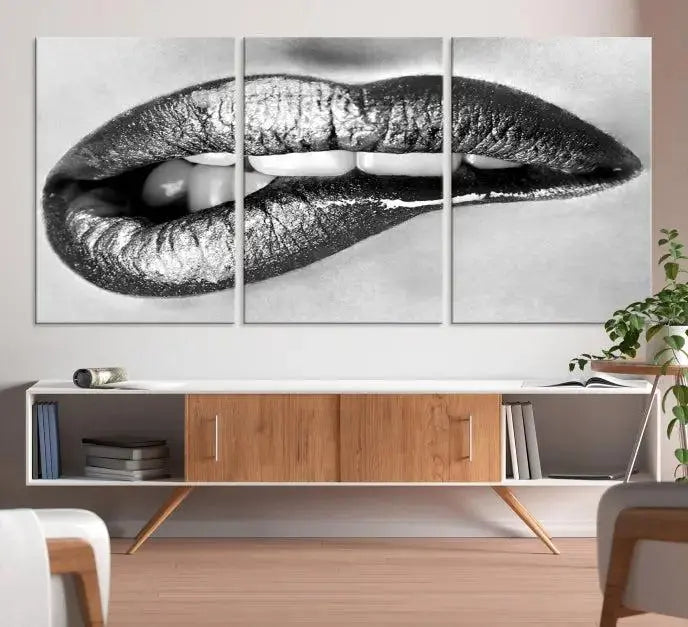 A striking triptych of Lip Bite Wall Art Canvas Print, featuring glossy metallic lips, gleams against a black background. Its UV-protective coating guarantees enduring vibrancy.