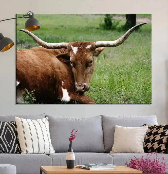 A triptych of the Longhorn Cow Animal Wall Art Canvas Print adorns the wall. These museum-quality canvases are gallery-wrapped and finished with a UV-protective coating for lasting beauty.