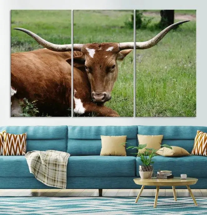 A triptych of the Longhorn Cow Animal Wall Art Canvas Print adorns the wall. These museum-quality canvases are gallery-wrapped and finished with a UV-protective coating for lasting beauty.