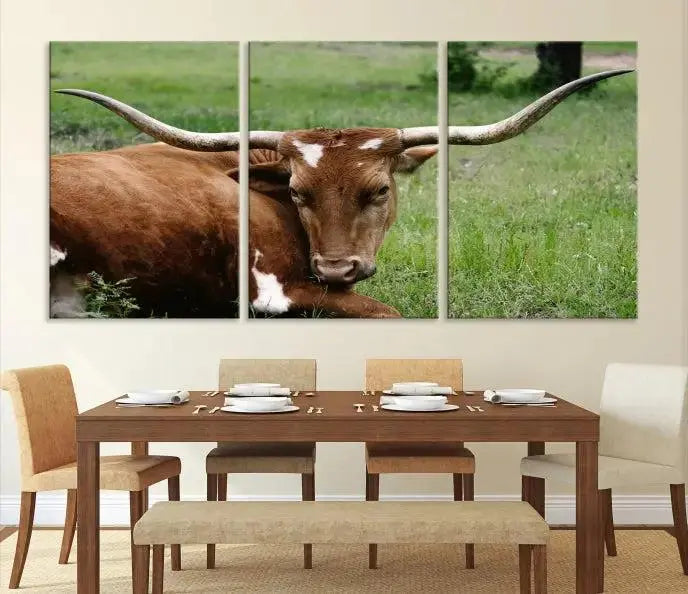 A triptych of the Longhorn Cow Animal Wall Art Canvas Print adorns the wall. These museum-quality canvases are gallery-wrapped and finished with a UV-protective coating for lasting beauty.