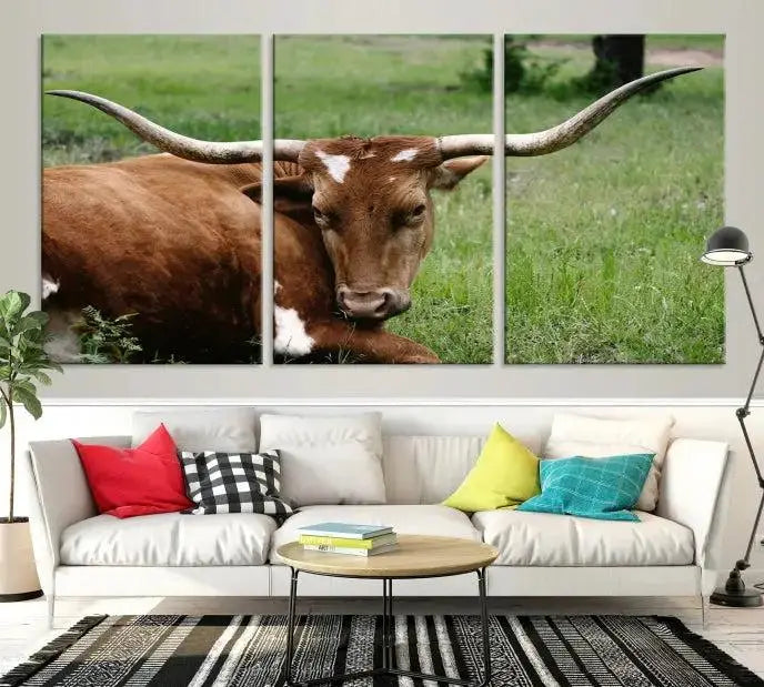 A triptych of the Longhorn Cow Animal Wall Art Canvas Print adorns the wall. These museum-quality canvases are gallery-wrapped and finished with a UV-protective coating for lasting beauty.