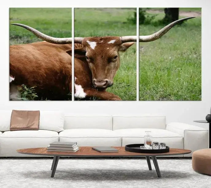 A triptych of the Longhorn Cow Animal Wall Art Canvas Print adorns the wall. These museum-quality canvases are gallery-wrapped and finished with a UV-protective coating for lasting beauty.