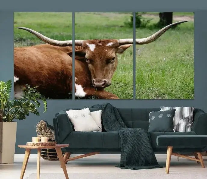 A triptych of the Longhorn Cow Animal Wall Art Canvas Print adorns the wall. These museum-quality canvases are gallery-wrapped and finished with a UV-protective coating for lasting beauty.