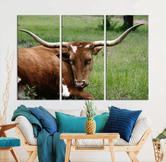 A triptych of the Longhorn Cow Animal Wall Art Canvas Print adorns the wall. These museum-quality canvases are gallery-wrapped and finished with a UV-protective coating for lasting beauty.