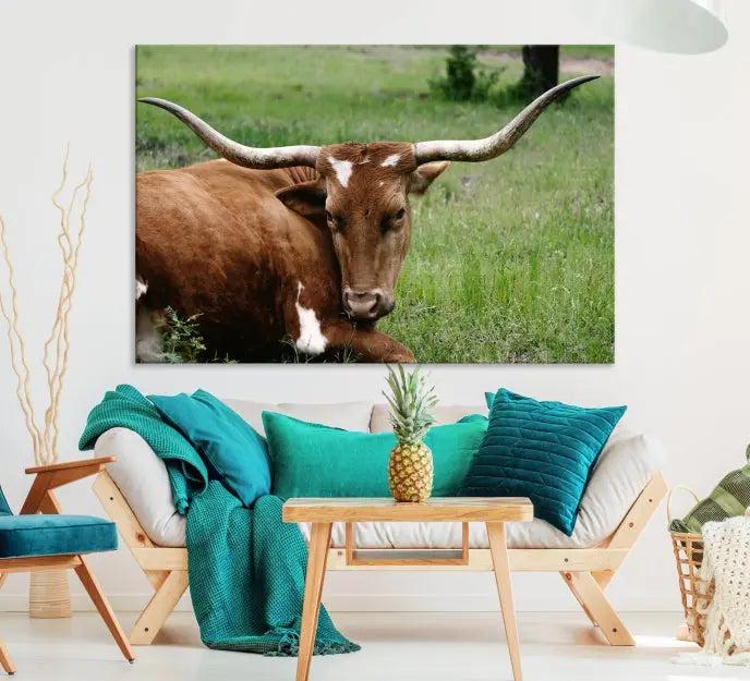 A triptych of the Longhorn Cow Animal Wall Art Canvas Print adorns the wall. These museum-quality canvases are gallery-wrapped and finished with a UV-protective coating for lasting beauty.