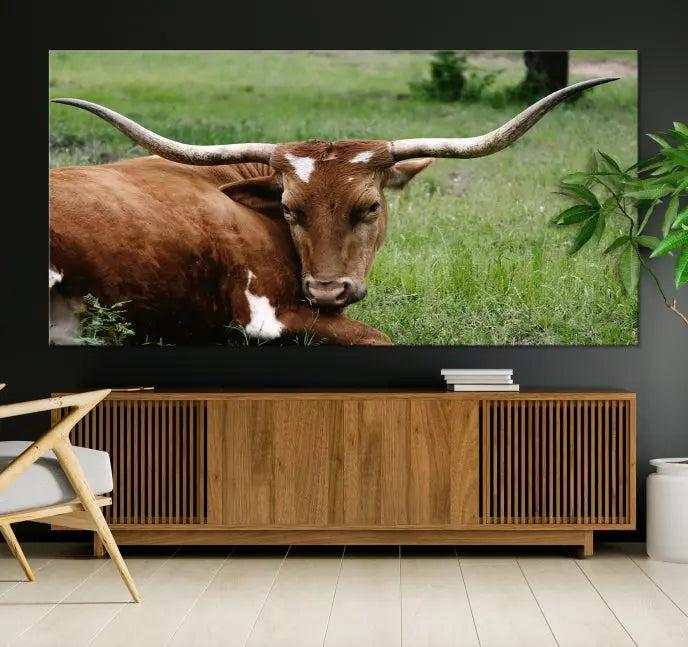 A triptych of the Longhorn Cow Animal Wall Art Canvas Print adorns the wall. These museum-quality canvases are gallery-wrapped and finished with a UV-protective coating for lasting beauty.