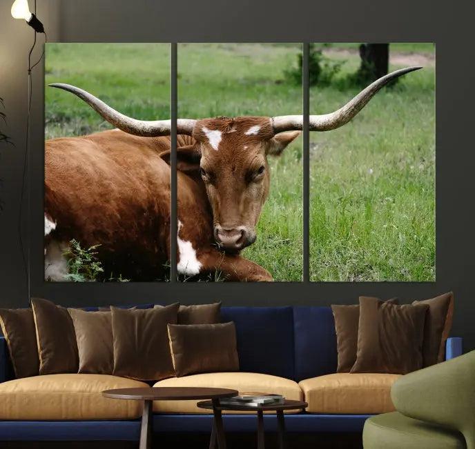 A triptych of the Longhorn Cow Animal Wall Art Canvas Print adorns the wall. These museum-quality canvases are gallery-wrapped and finished with a UV-protective coating for lasting beauty.