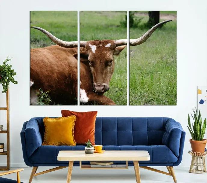 A triptych of the Longhorn Cow Animal Wall Art Canvas Print adorns the wall. These museum-quality canvases are gallery-wrapped and finished with a UV-protective coating for lasting beauty.