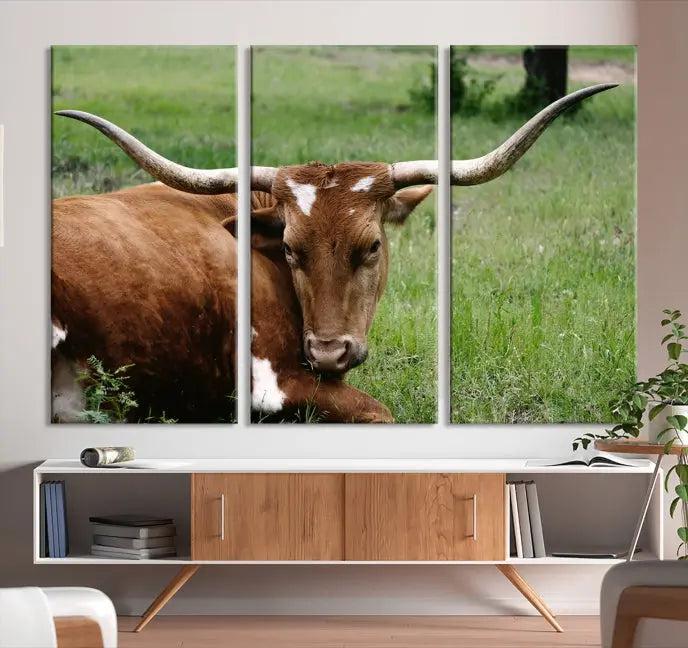 A triptych of the Longhorn Cow Animal Wall Art Canvas Print adorns the wall. These museum-quality canvases are gallery-wrapped and finished with a UV-protective coating for lasting beauty.