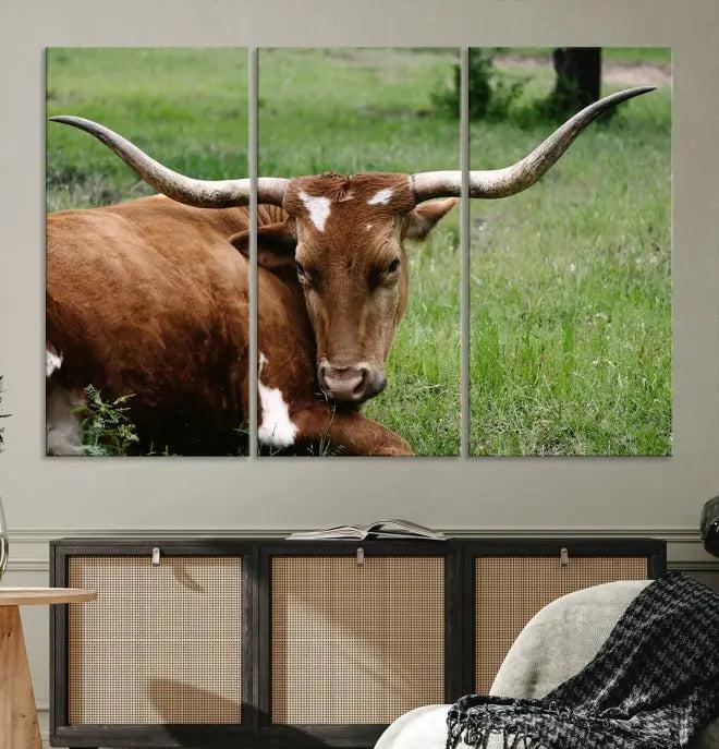 A triptych of the Longhorn Cow Animal Wall Art Canvas Print adorns the wall. These museum-quality canvases are gallery-wrapped and finished with a UV-protective coating for lasting beauty.