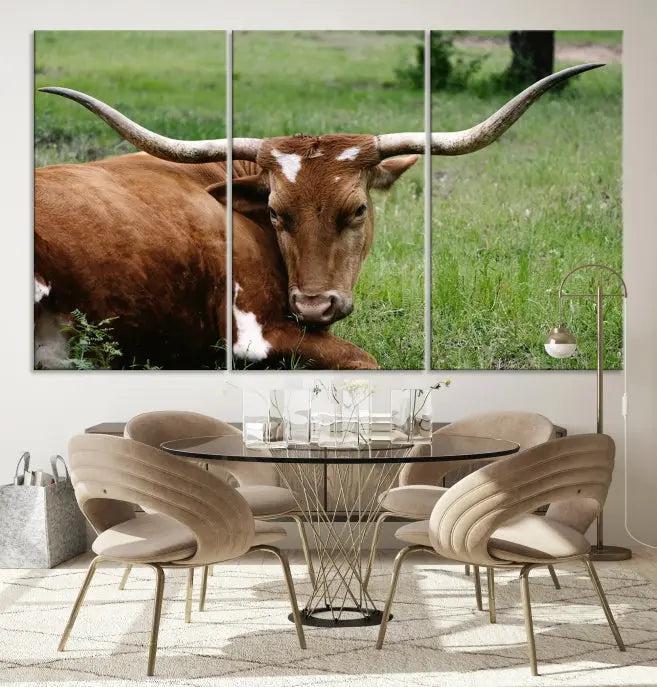 A triptych of the Longhorn Cow Animal Wall Art Canvas Print adorns the wall. These museum-quality canvases are gallery-wrapped and finished with a UV-protective coating for lasting beauty.