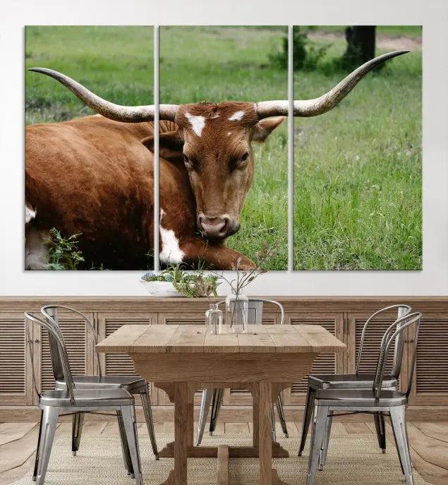 A triptych of the Longhorn Cow Animal Wall Art Canvas Print adorns the wall. These museum-quality canvases are gallery-wrapped and finished with a UV-protective coating for lasting beauty.