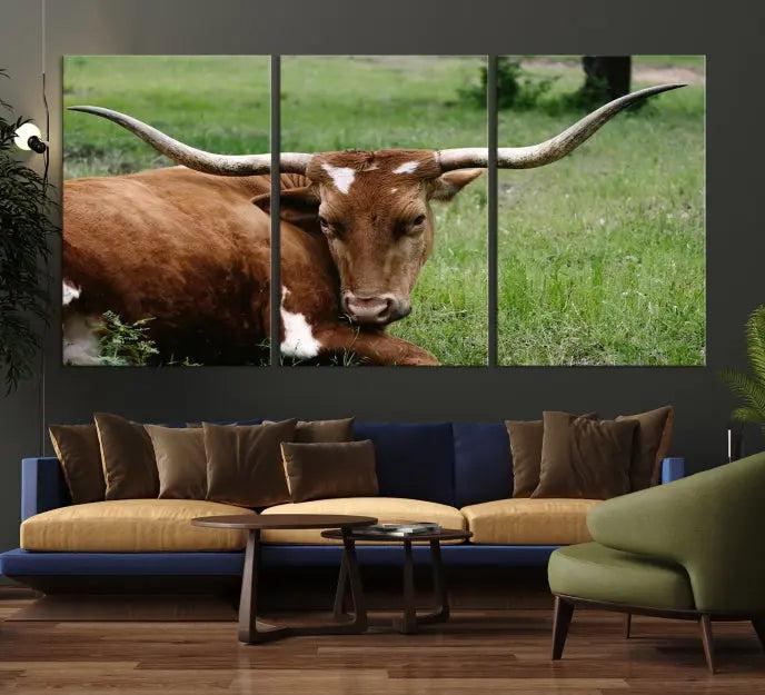 A triptych of the Longhorn Cow Animal Wall Art Canvas Print adorns the wall. These museum-quality canvases are gallery-wrapped and finished with a UV-protective coating for lasting beauty.