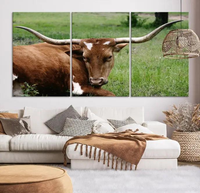 A triptych of the Longhorn Cow Animal Wall Art Canvas Print adorns the wall. These museum-quality canvases are gallery-wrapped and finished with a UV-protective coating for lasting beauty.