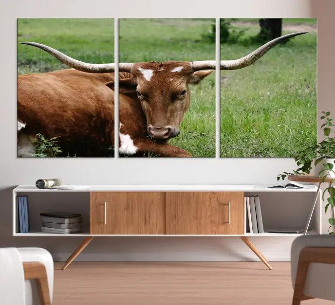 A triptych of the Longhorn Cow Animal Wall Art Canvas Print adorns the wall. These museum-quality canvases are gallery-wrapped and finished with a UV-protective coating for lasting beauty.