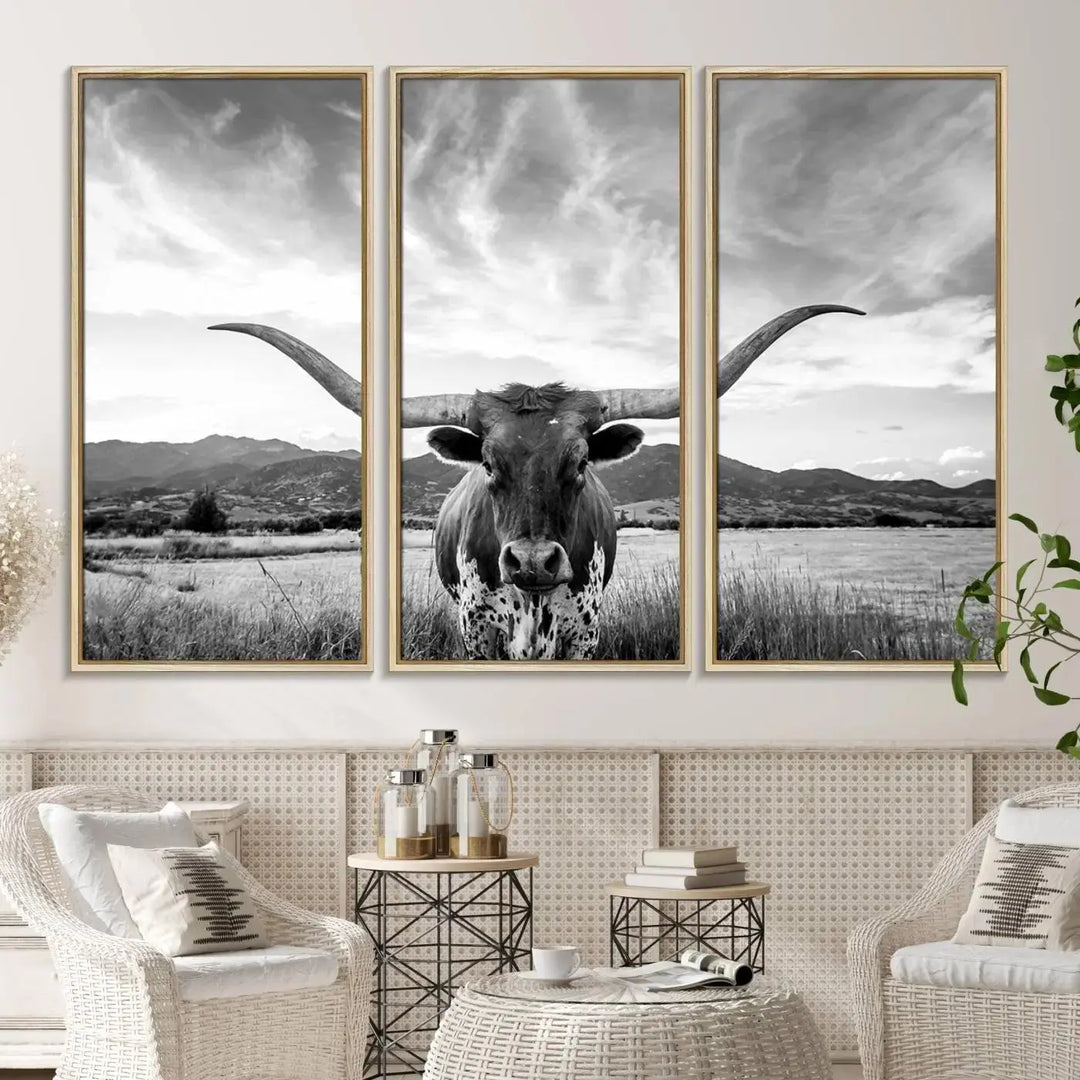 A modern living room showcases a black and white triptych of the "Longhorn Cow Wall Art Canvas Print Farmhouse Wall Art Texas longhorn wall art.