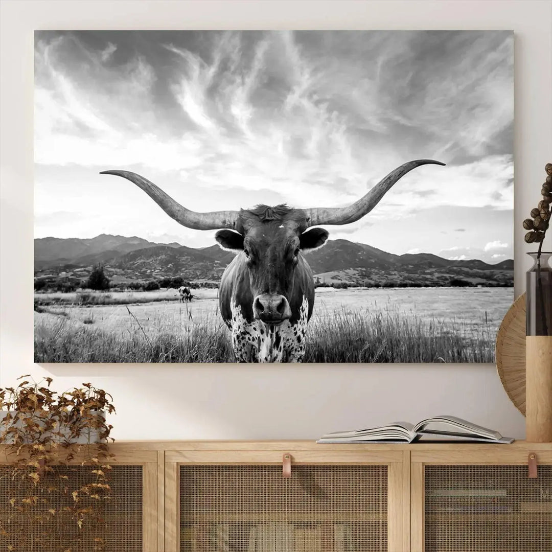 A modern living room showcases a black and white triptych of the "Longhorn Cow Wall Art Canvas Print Farmhouse Wall Art Texas longhorn wall art.