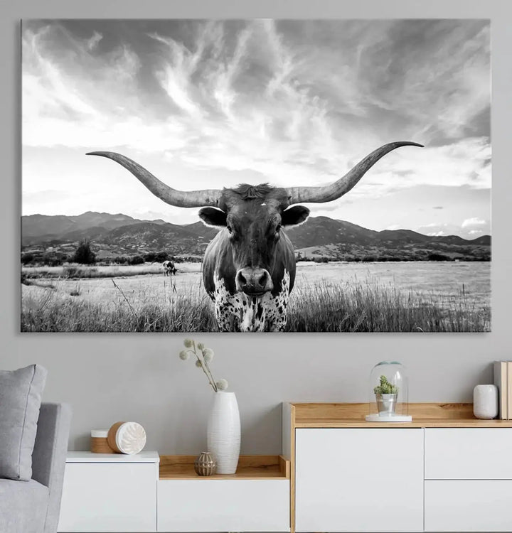 A modern living room showcases a black and white triptych of the "Longhorn Cow Wall Art Canvas Print Farmhouse Wall Art Texas longhorn wall art.