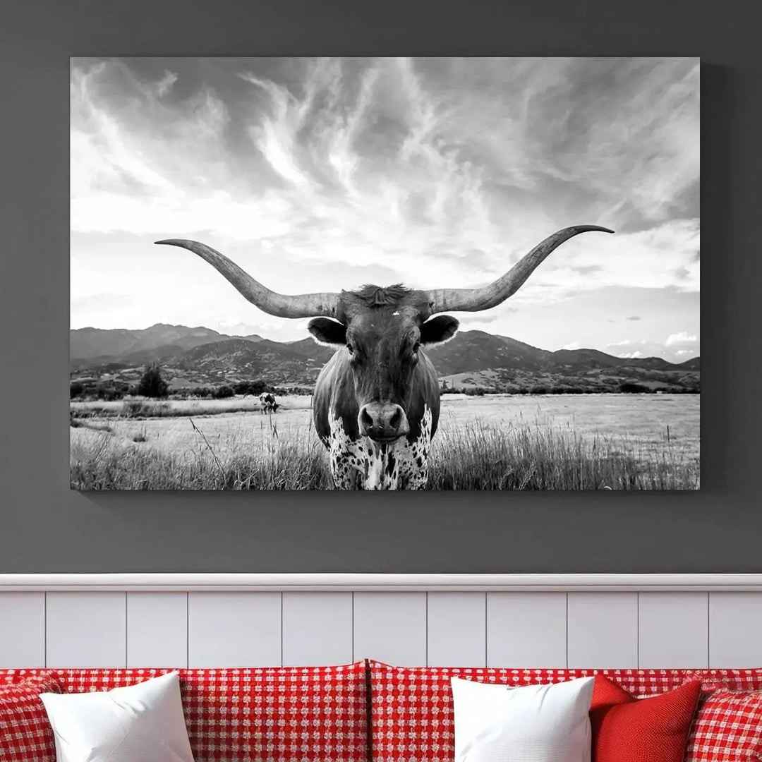 A modern living room showcases a black and white triptych of the "Longhorn Cow Wall Art Canvas Print Farmhouse Wall Art Texas longhorn wall art.