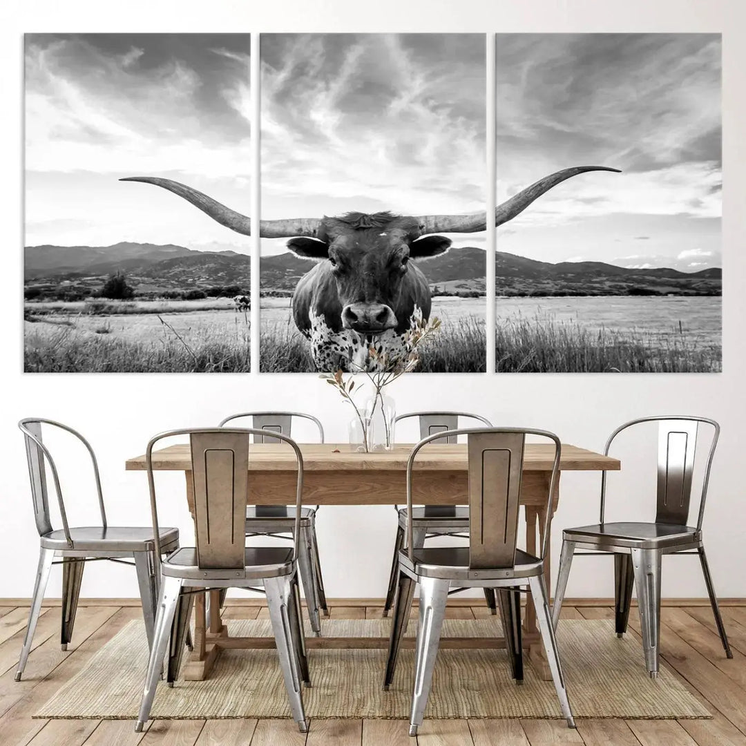 A modern living room showcases a black and white triptych of the "Longhorn Cow Wall Art Canvas Print Farmhouse Wall Art Texas longhorn wall art.