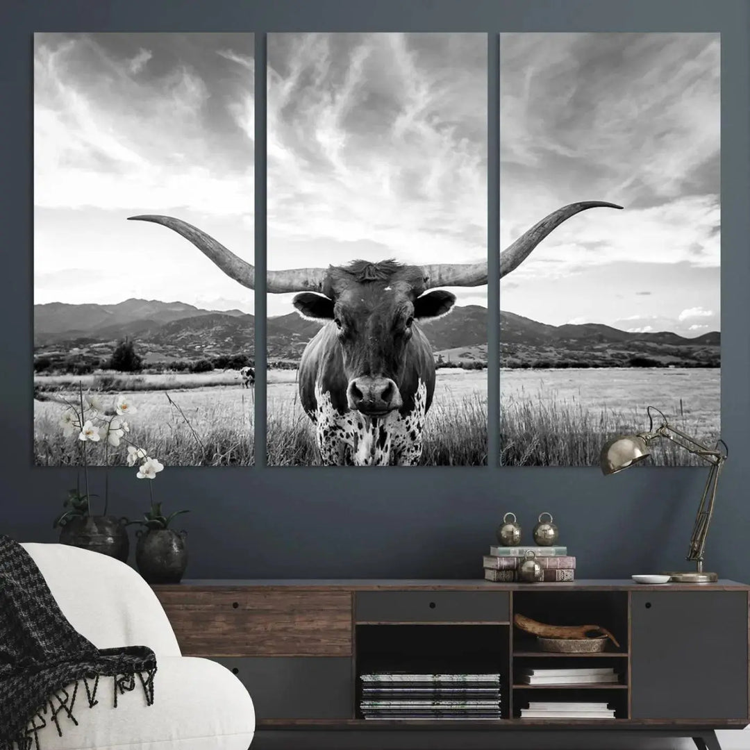 A modern living room showcases a black and white triptych of the "Longhorn Cow Wall Art Canvas Print Farmhouse Wall Art Texas longhorn wall art.