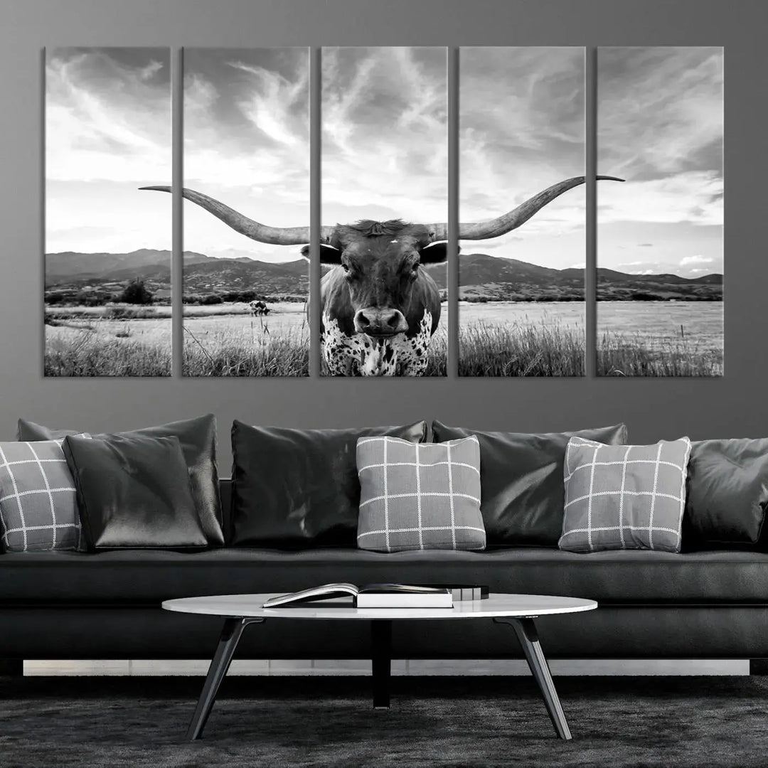 A modern living room showcases a black and white triptych of the "Longhorn Cow Wall Art Canvas Print Farmhouse Wall Art Texas longhorn wall art.