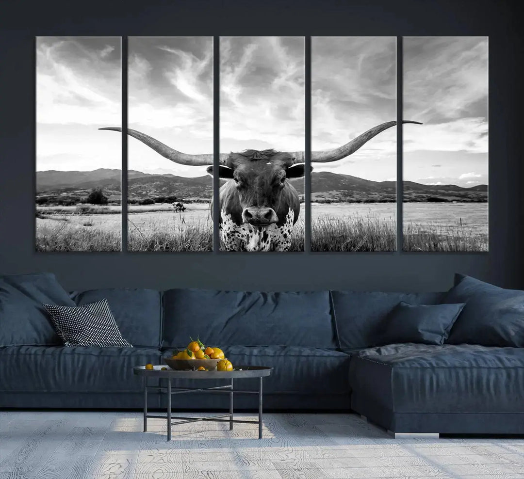 A modern living room showcases a black and white triptych of the "Longhorn Cow Wall Art Canvas Print Farmhouse Wall Art Texas longhorn wall art.