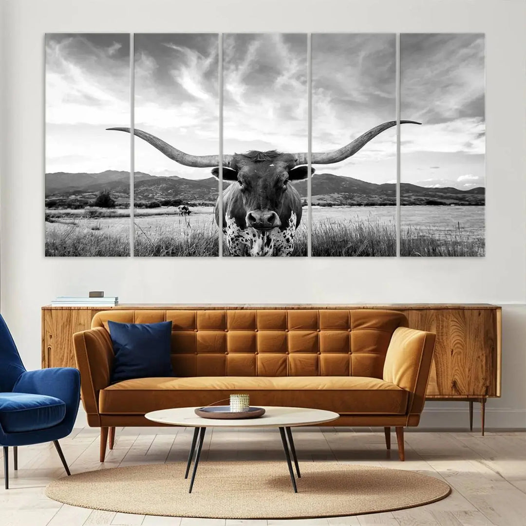 A modern living room showcases a black and white triptych of the "Longhorn Cow Wall Art Canvas Print Farmhouse Wall Art Texas longhorn wall art.