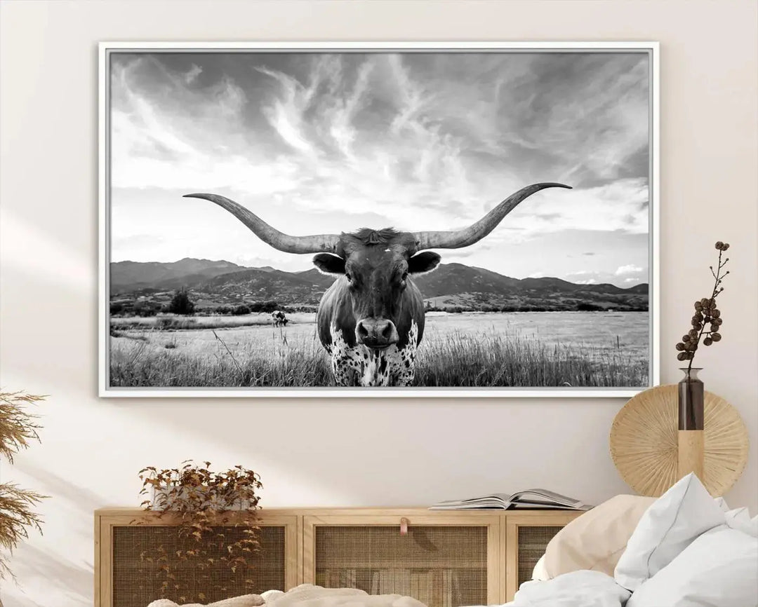 A modern living room showcases a black and white triptych of the "Longhorn Cow Wall Art Canvas Print Farmhouse Wall Art Texas longhorn wall art.