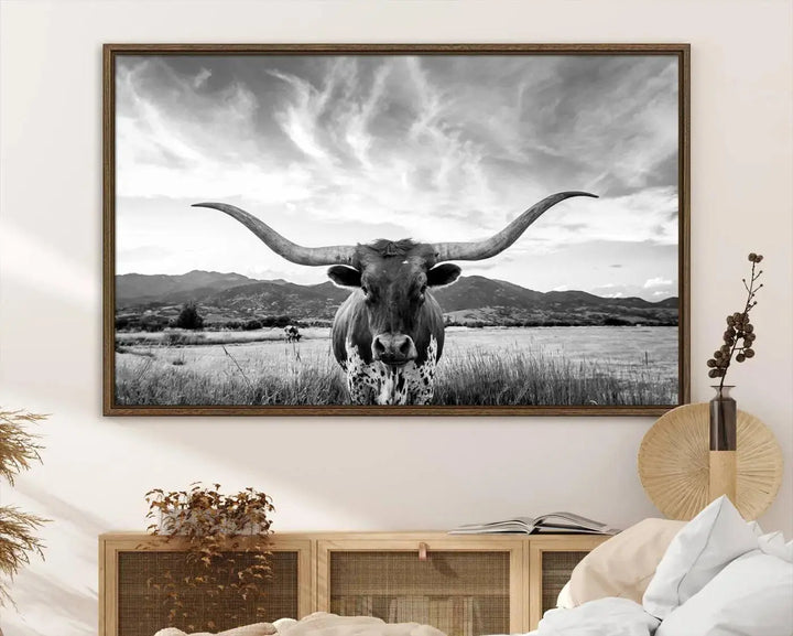 A modern living room showcases a black and white triptych of the "Longhorn Cow Wall Art Canvas Print Farmhouse Wall Art Texas longhorn wall art.