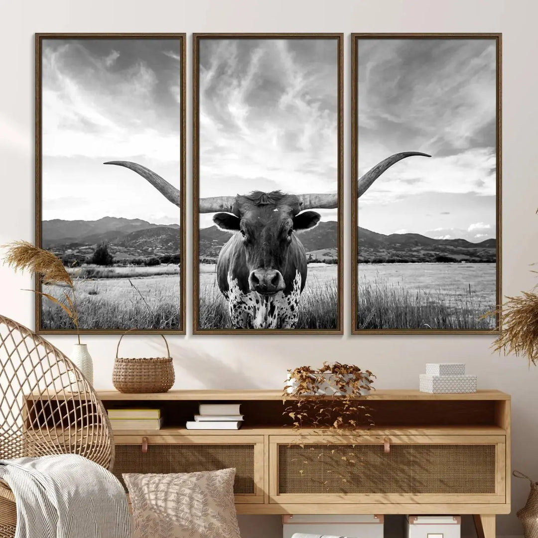 A modern living room showcases a black and white triptych of the "Longhorn Cow Wall Art Canvas Print Farmhouse Wall Art Texas longhorn wall art.