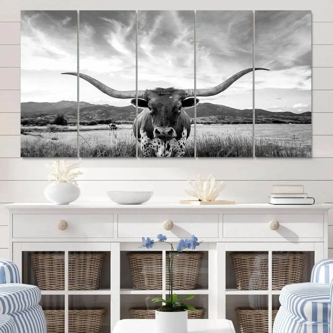 A modern living room showcases a black and white triptych of the "Longhorn Cow Wall Art Canvas Print Farmhouse Wall Art Texas longhorn wall art.